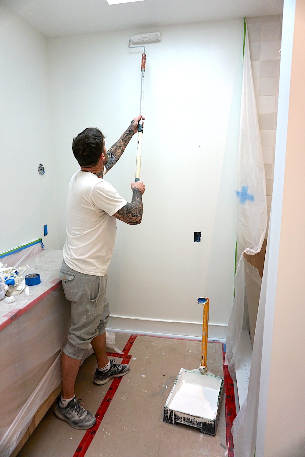 Blue World Painting team applying fresh paint to a residential home's exterior using high-quality equipment, ensuring a smooth, even finish.